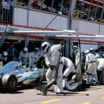 An executive contemplating a career transition, comparing it to a Formula 1 pit stop.