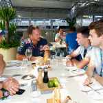 A corporate leader morphing into an F1 team principal, representing the strategic role of a Chief Product Officer.