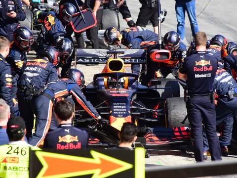 A dynamic F1 team working on a racing car representing a C-suite team working towards business success.