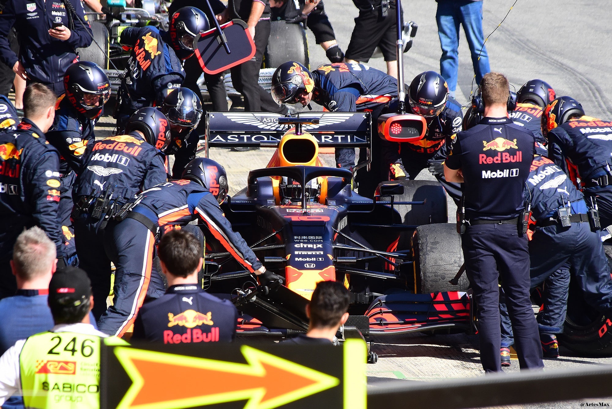 A dynamic F1 team working on a racing car representing a C-suite team working towards business success.