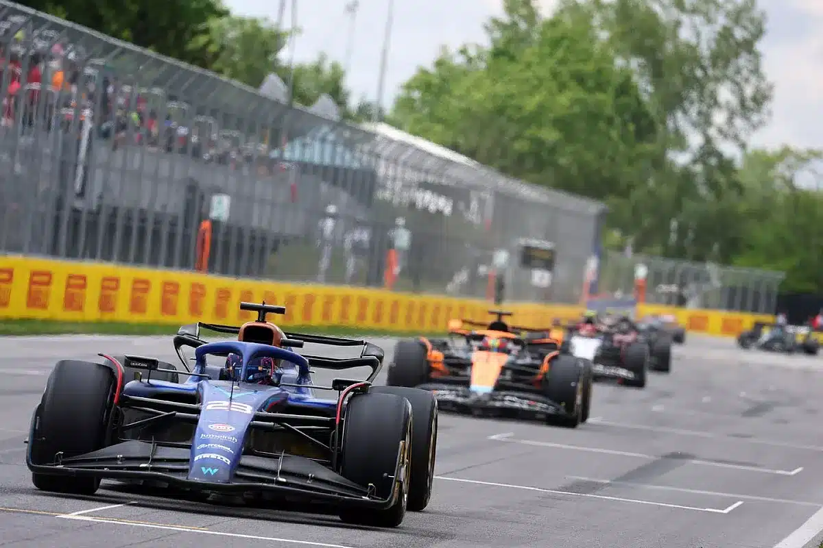 Formula 1 car alongside business executives symbolizing the link between F1 strategies and future HR leadership.