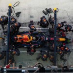 Formula 1 pit stop efficiency combined with COO strategic planning in a boardroom.