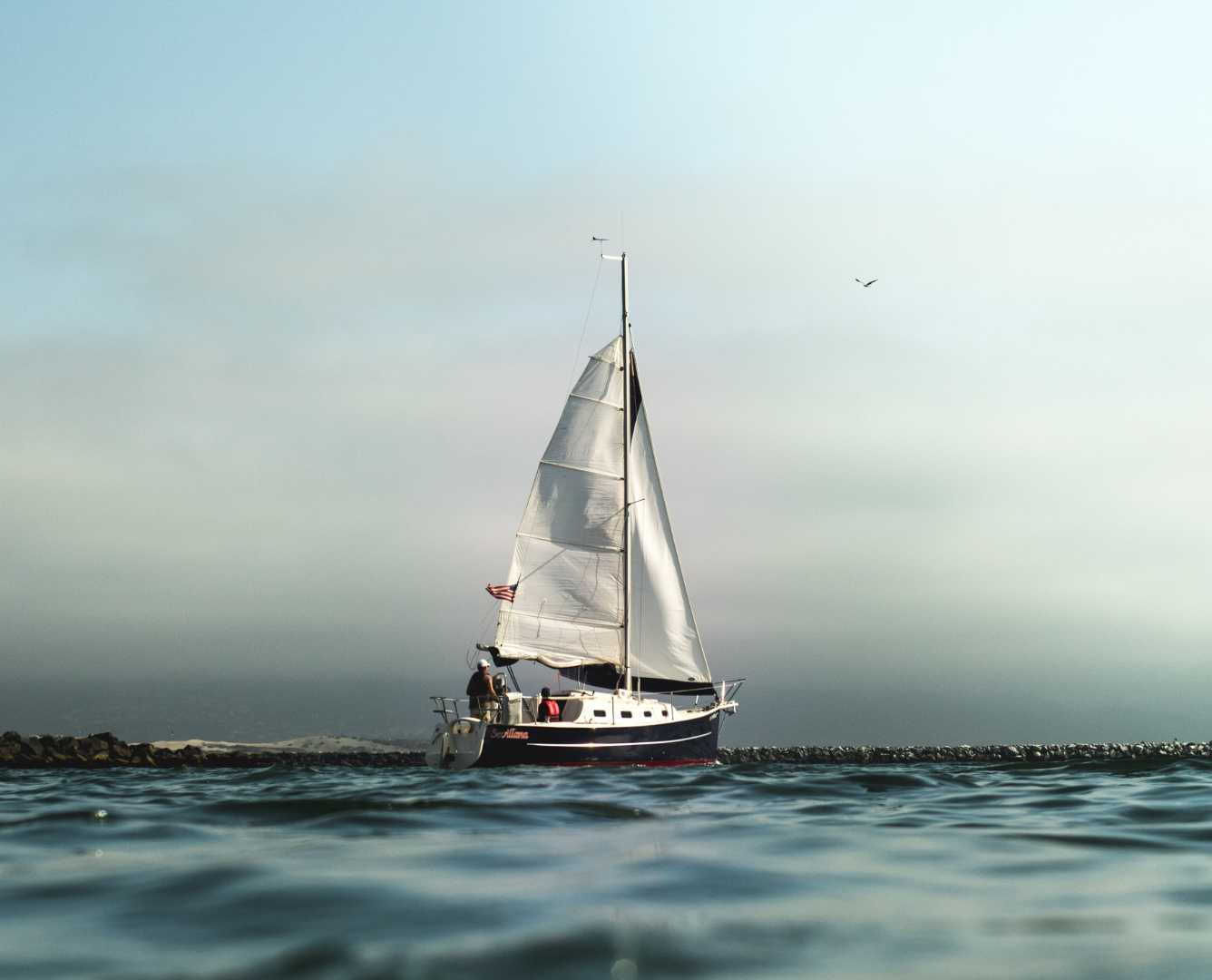 Sailboat navigating the ocean with a compass - representing the strategic journey of nearshoring and executive search