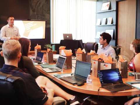 Group of diverse executive strategizing in a Mexico City boardroom, symbolizing the role of executive search firms in Mexican economic growth.