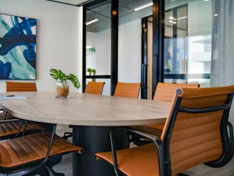 Diverse group of professionals in a boardroom, symbolizing the role of Non-Executive Directors in corporate governance.