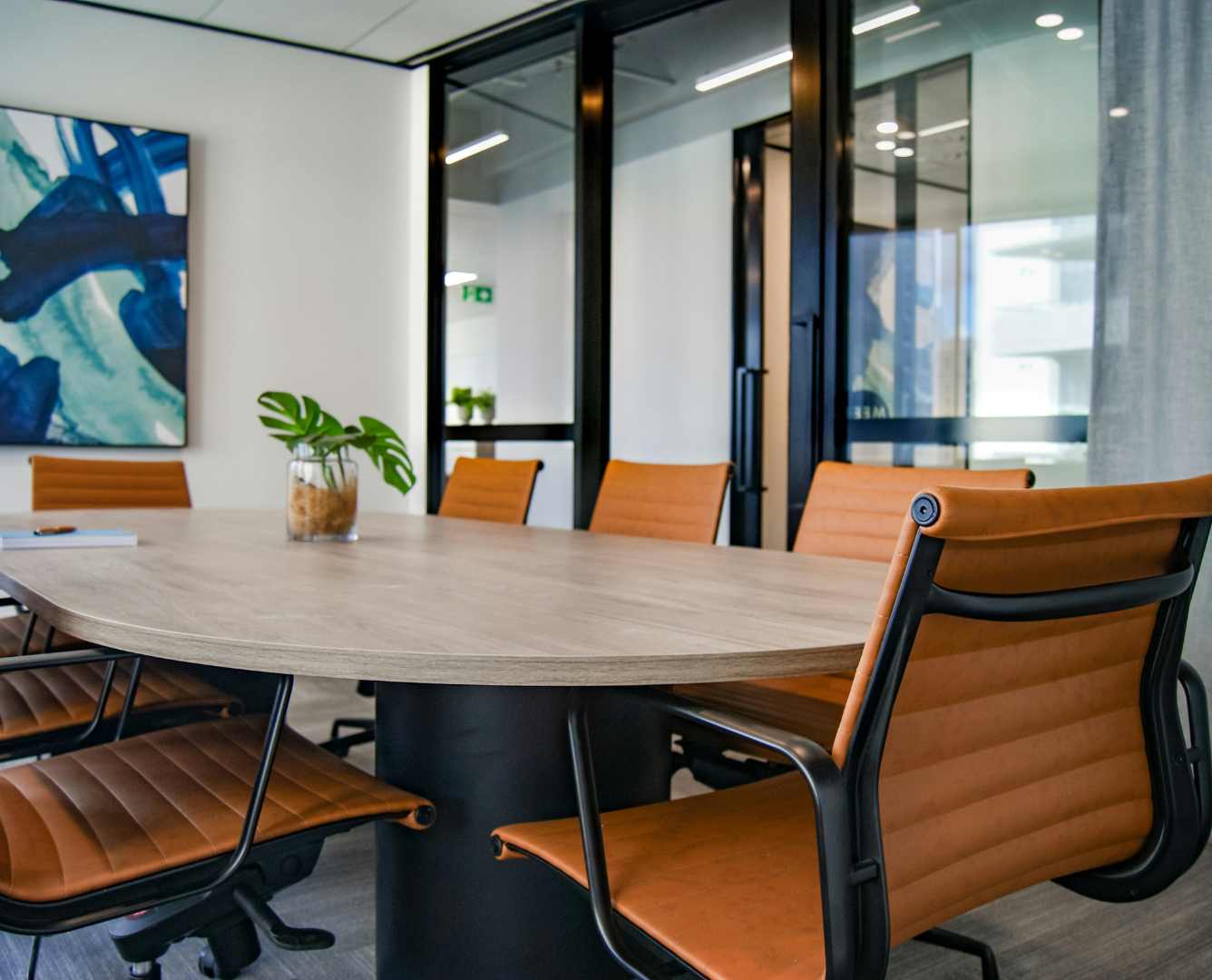 Diverse group of professionals in a boardroom, symbolizing the role of Non-Executive Directors in corporate governance.