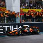 McLaren MCL38 Formula 1 car in iconic papaya orange livery racing on track during 2024 championship-winning season, illustrating the complete team approach to sustained manufacturing excellence