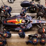 Formula 1 Red Bull Racing pit crew performing precise tire change demonstrating strategic timing for executive hiring decisions