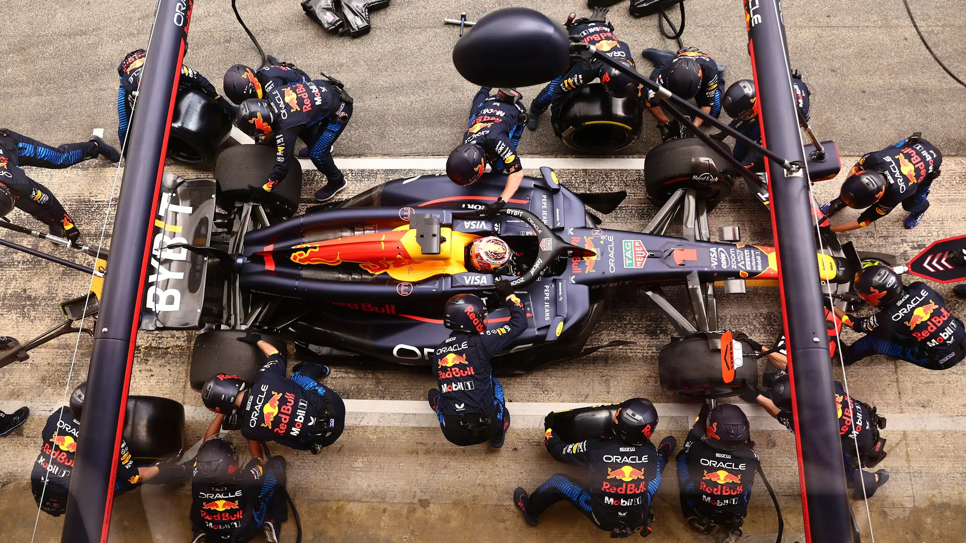 Formula 1 Red Bull Racing pit crew performing precise tire change demonstrating strategic timing for executive hiring decisions