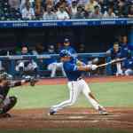 Baseball player reaching first base safely - representing on-base percentage executive hiring strategy