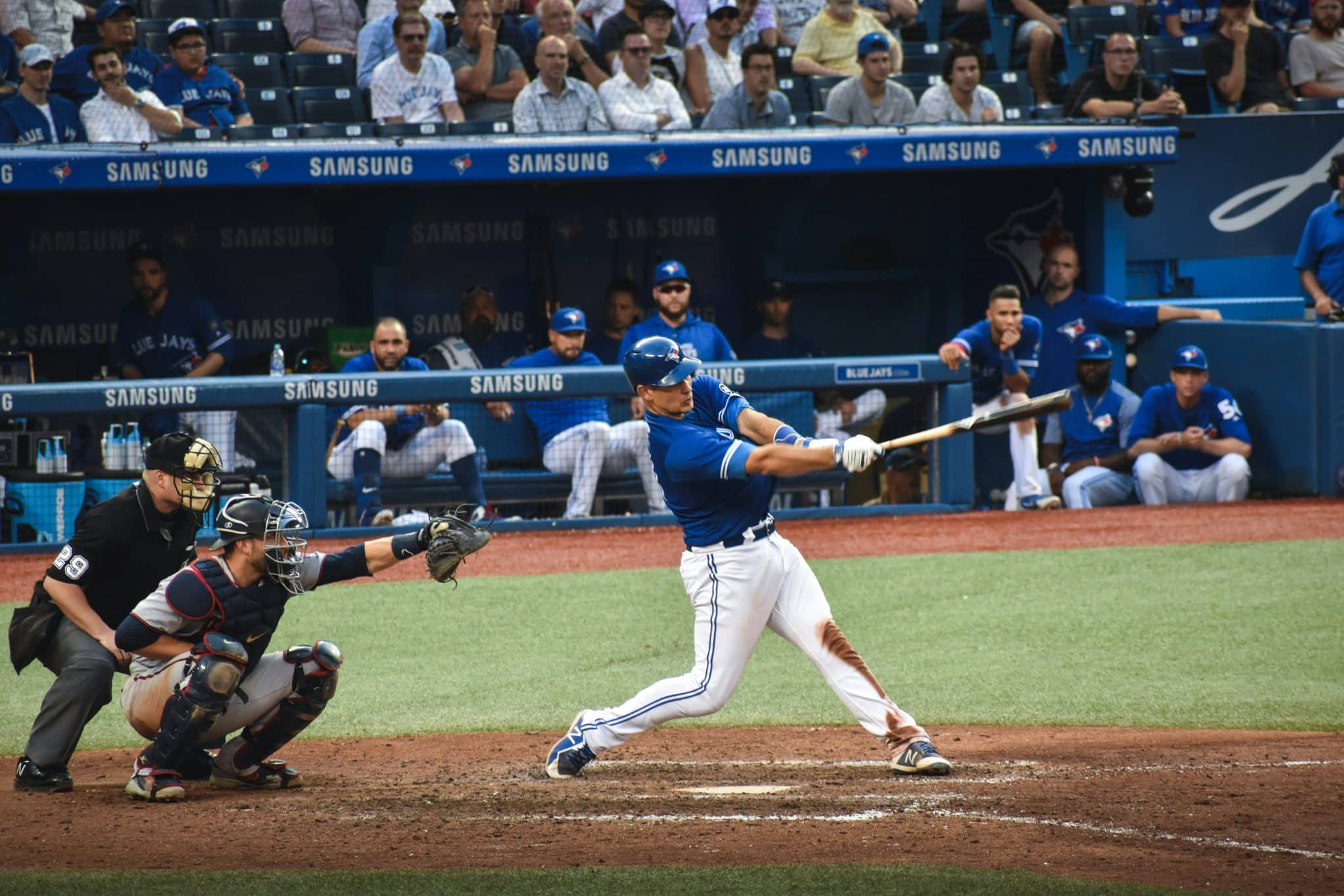 Baseball player reaching first base safely - representing on-base percentage executive hiring strategy