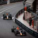 Red Bull Racing teammates Max Verstappen and Sergio Pérez navigating Monaco's tight hairpin turn during the 2023 Monaco Grand Prix, illustrating the delicate balance between Number One and Number Two drivers in F1's most demanding street circuit