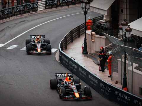 Red Bull Racing teammates Max Verstappen and Sergio Pérez navigating Monaco's tight hairpin turn during the 2023 Monaco Grand Prix, illustrating the delicate balance between Number One and Number Two drivers in F1's most demanding street circuit