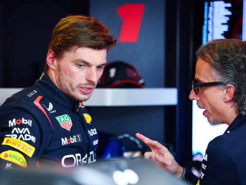 F1 pit wall with team leadership analyzing different data representing board and founder seeing same situation differently