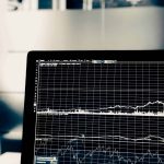 Private equity deal room with financial metrics and leadership assessment frameworks representing condition diagnosis during due diligence
