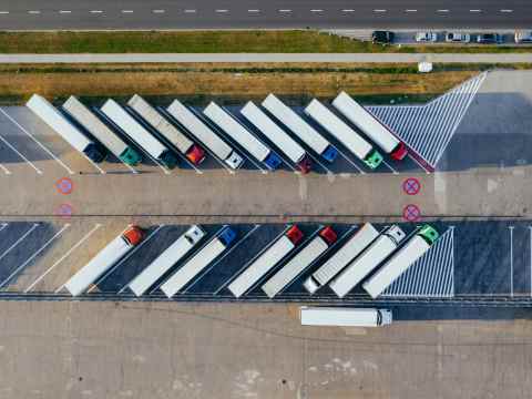 Cross-Border Leadership Nearshoring Gap: F1 pit wall telemetry screens displaying US-Mexico cross-border corridor map representing leadership strategy gap in nearshoring operations