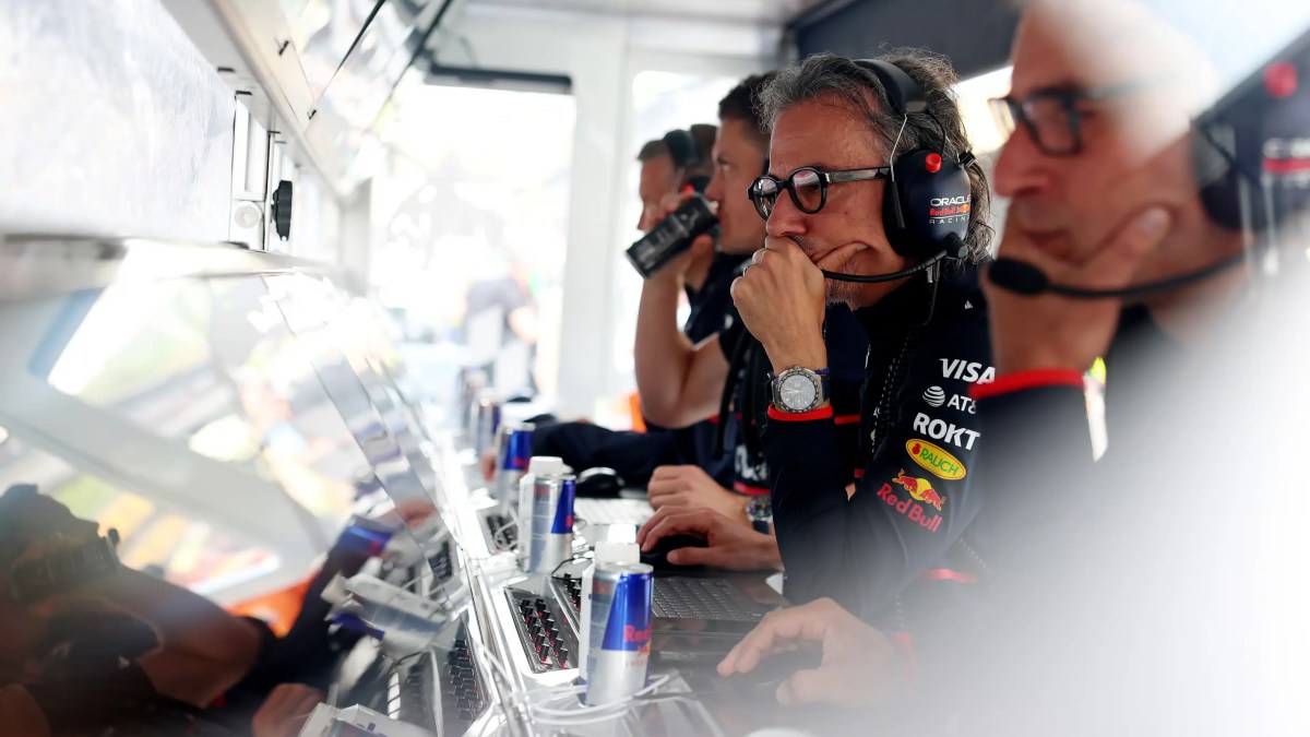 F1 pit wall during a race, representing the organizational support structures executives rely on for critical decisions