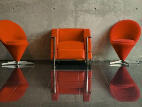 Three boardroom chairs casting distinctly different shadows, representing three CHRO failure modes: compliance calibration, strategy without execution, and comfort promotion