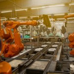 A modern Mexican manufacturing or industrial facility with a senior leader in a position of authority — conveying strategic operation rather than a low-cost back office.