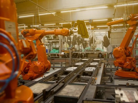 A modern Mexican manufacturing or industrial facility with a senior leader in a position of authority — conveying strategic operation rather than a low-cost back office.