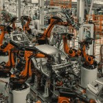 Manufacturing plant floor transitioning from standardized stations to improvised fixtures, cross-border operations leadership