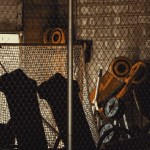 Sports Executive Search Conflicts: Locked storage cage in a stadium tunnel, evoking restricted access in sports executive search