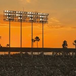 Empty stadium owner's box at dusk, symbolizing a sports ownership transition