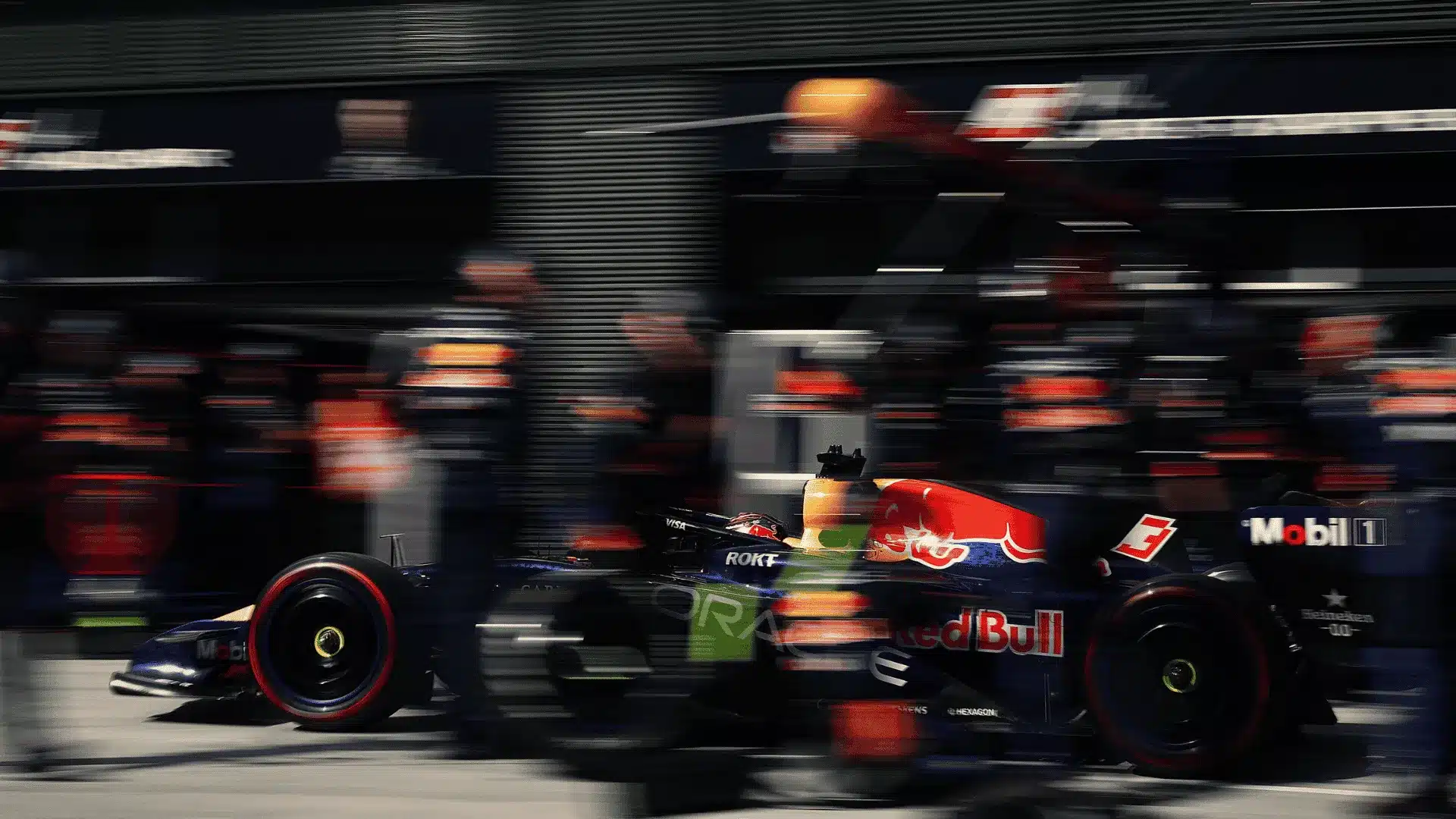 Formula 1 garage with a car mid-rebuild on stands, symbolizing executive hiring readiness before results