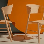 Two office chairs facing each other across a small table, representing founder-led company authority under negotiation