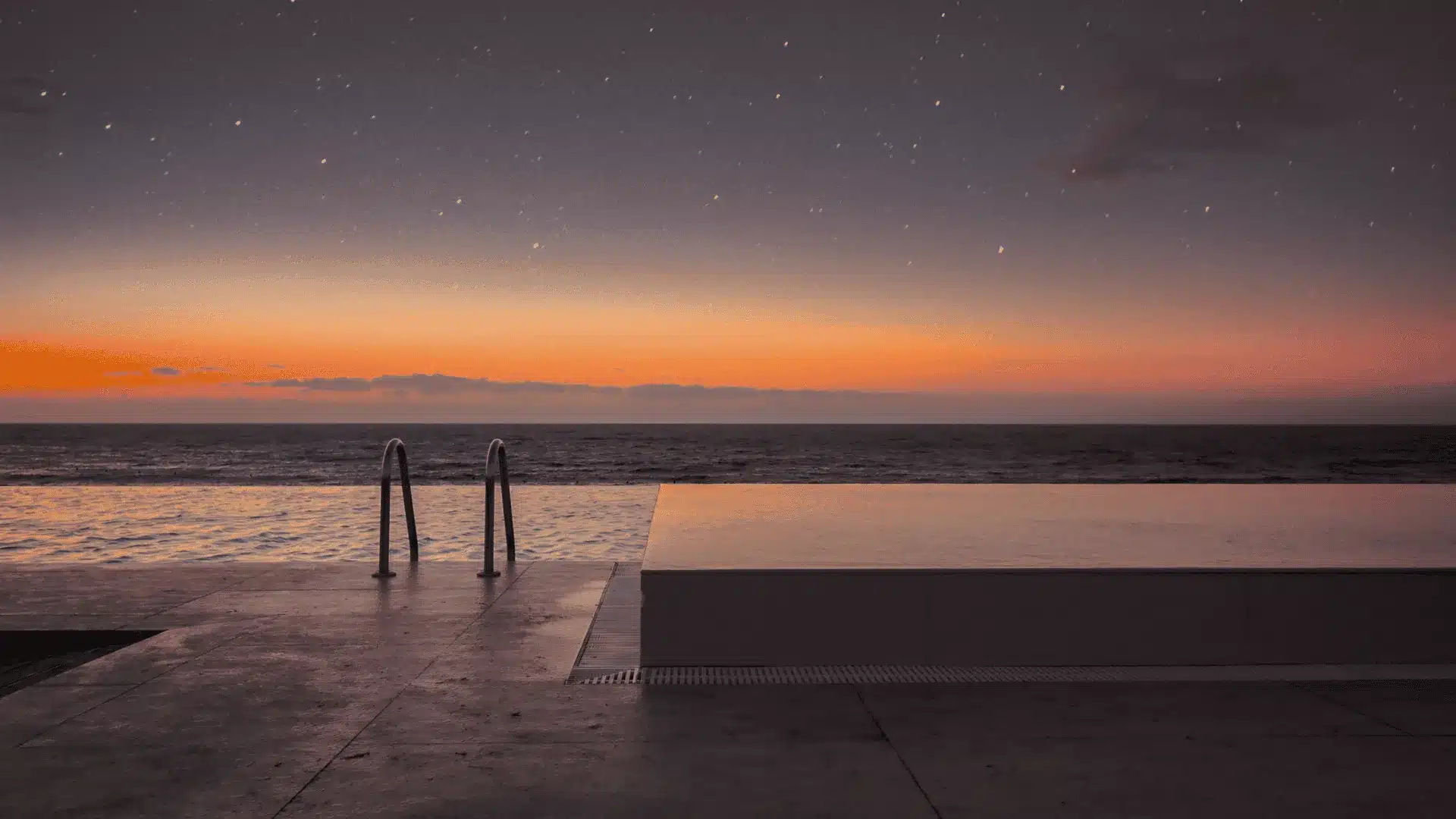 Infinity pool edge meeting the horizon at dawn, representing the resort general manager's role between brand and asset