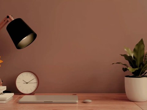 Silent desk phone on a busy-looking desk, representing the shift from AI and executive judgment to direction over execution