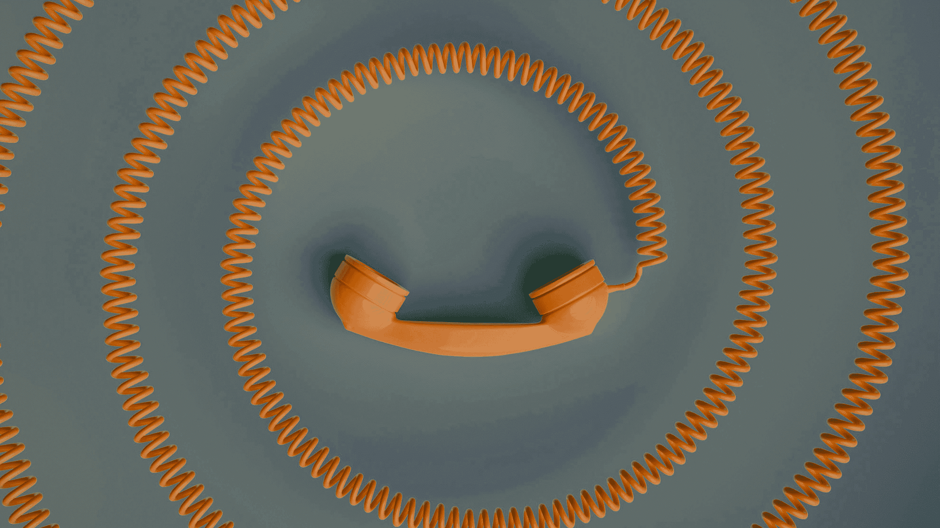 Phone lit with a chat conversation on a desk beside an empty office chair, representing the first American executive hire waiting on approval